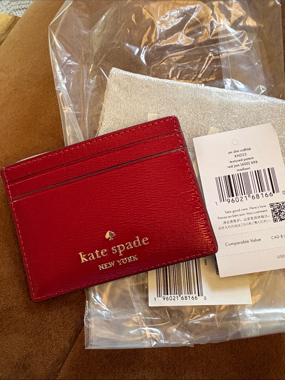 Kate Spade “red jam” textured patent leather slim card case with gold logo